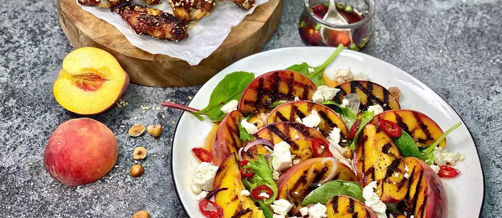 Salat von gegrilltem Pfirsich mit Sesam-Chickenwings